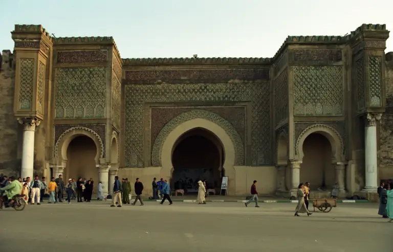 Crowds in front of the tiled Bab Mansour gate in Meknes, Morocco