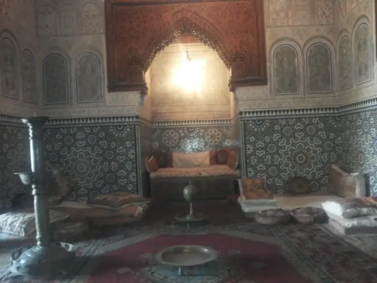 Painted ceiling and rugs in a room of the Dar Jamai museum in Meknes