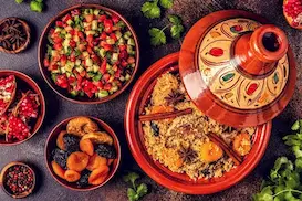 Moroccan tagine, couscous and salads served in traditional red dishes