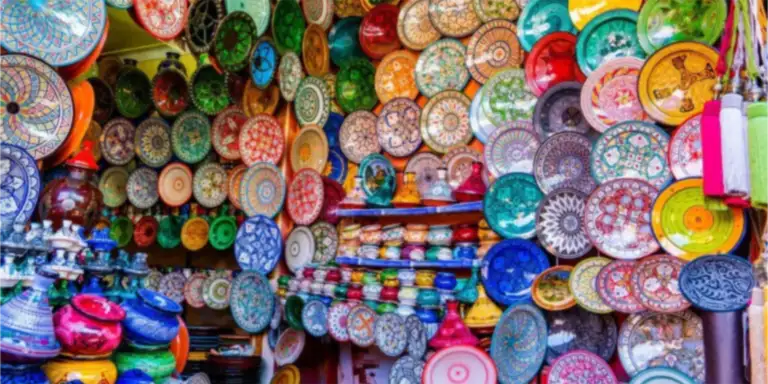 Hand-painted Moroccan ceramic plates stacked at a craft market stall
