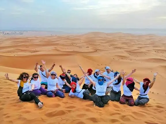 Morocco student tours: a school group on the Erg Chebbi dunes in the Sahara