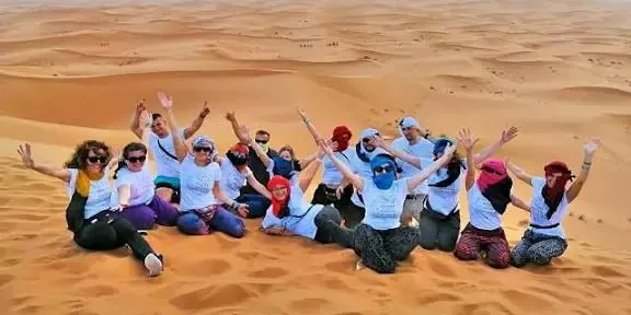 A student group on the Sahara dunes in Morocco